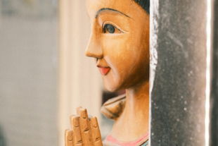 wooden-statue-of-a-woman-with-hands-clasped.jpg Wooden statue of a woman with hands clasped